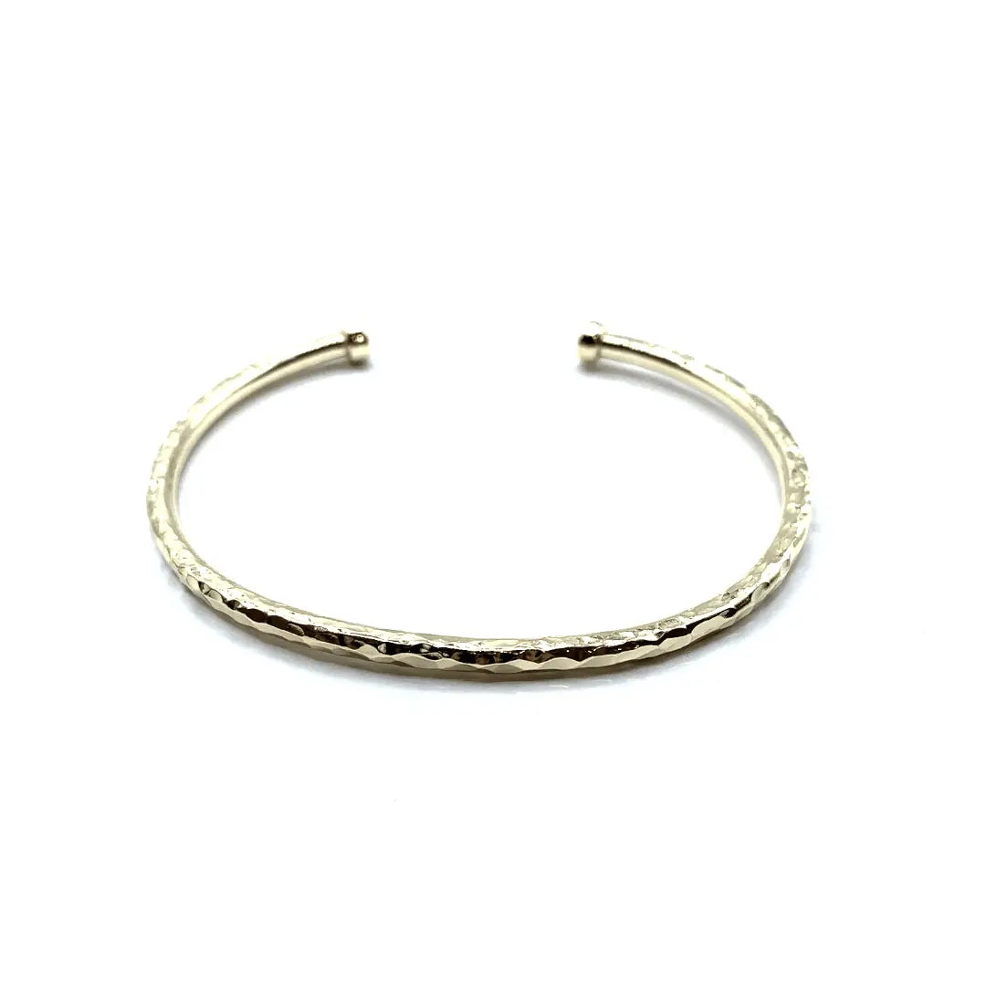 Hammered 14k gold-filled cuff bracelet from Erin Gray, featuring a textured, artisan-style jewelry design.