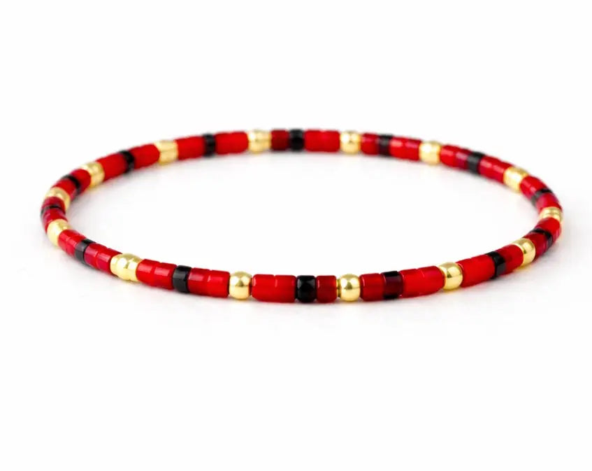 Endless Summer 14k gold-filled and rich red beaded bracelet by Erin Gray, showcasing vibrant red beads and gold accents.