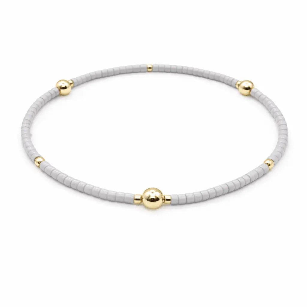 Gray and gold-filled jewelry bracelet with "Game Day" engraved, by erin gray, featuring stylish and durable design.
