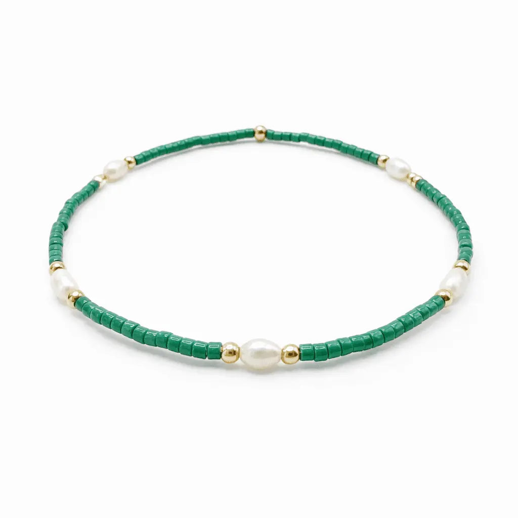 Green and gold waterproof bracelets featuring pearl accents from erin gray's Game Day jewelry collection.