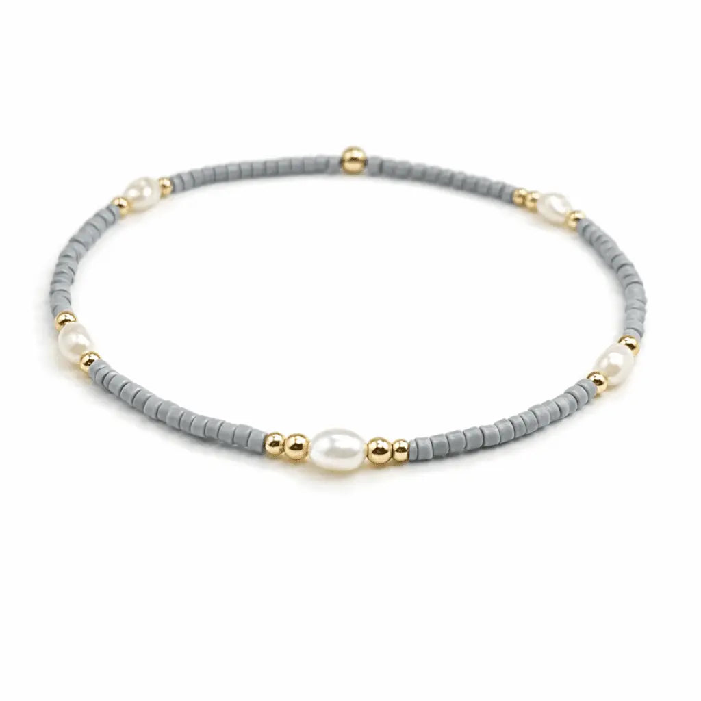 Gray and gold-filled waterproof bracelets with pearl accents from erin gray's Game Day jewelry collection.