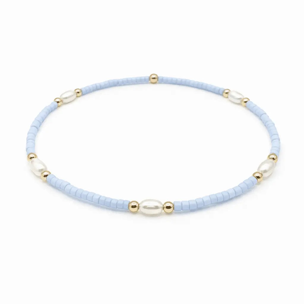 Light blue, gold-filled waterproof bracelets from erin gray's Game Day jewelry collection featuring pearl accents and adjustable fit.