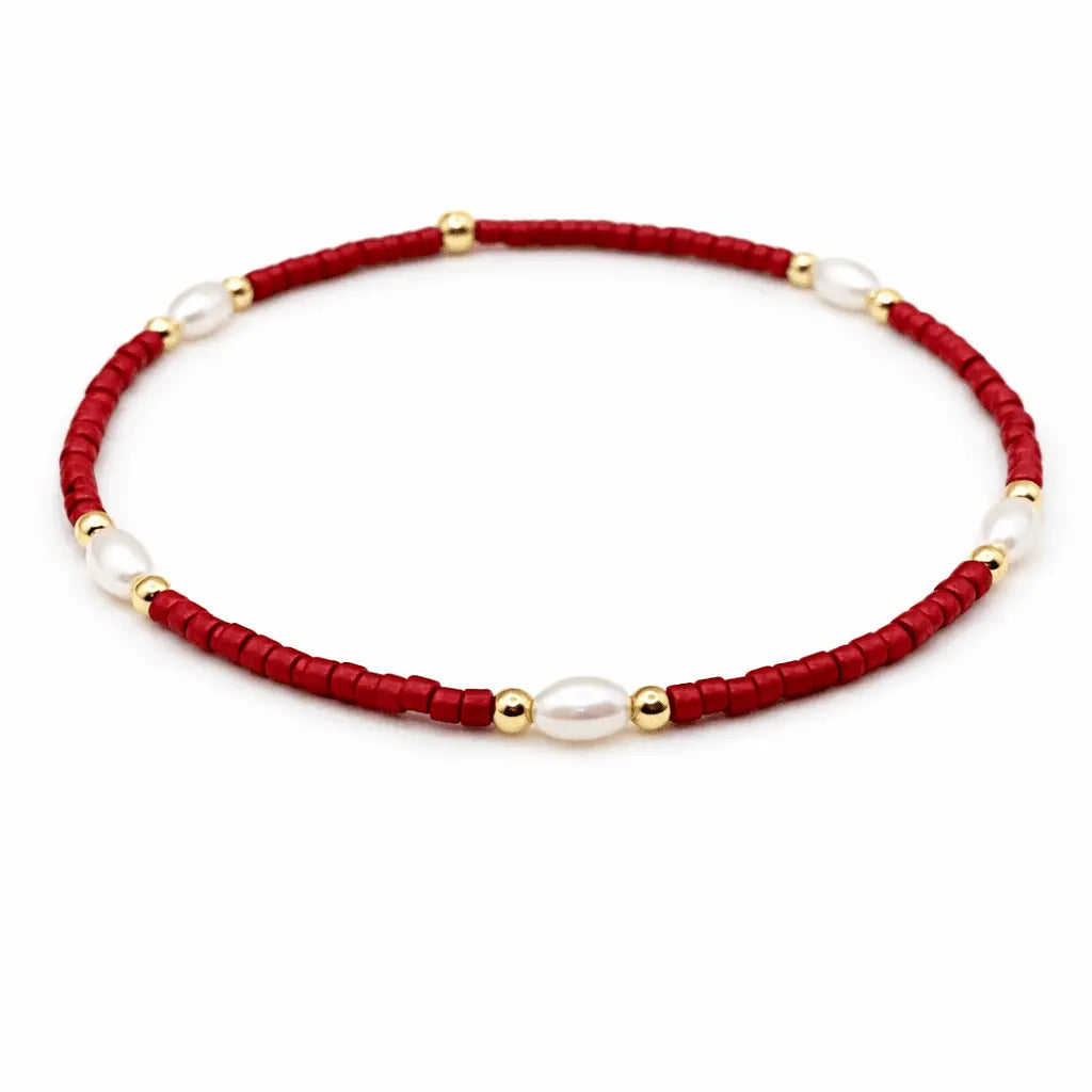 Red and gold-filled waterproof bracelets with pearl accents from erin gray's Game Day jewelry collection.