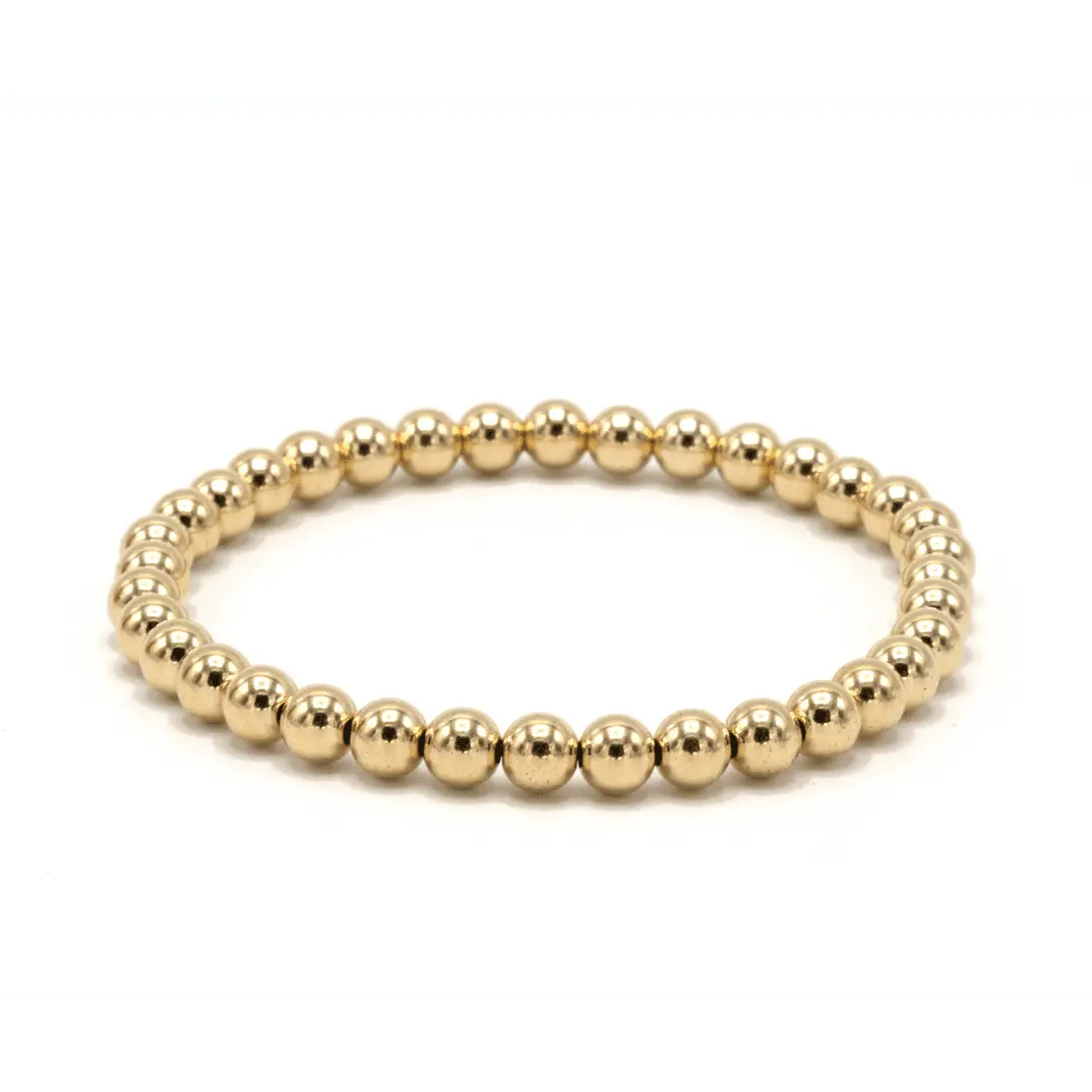 Gold-filled Karma bracelet with 5mm waterproof beads, crafted by erin gray, showcasing elegant jewelry design on a neutral background.