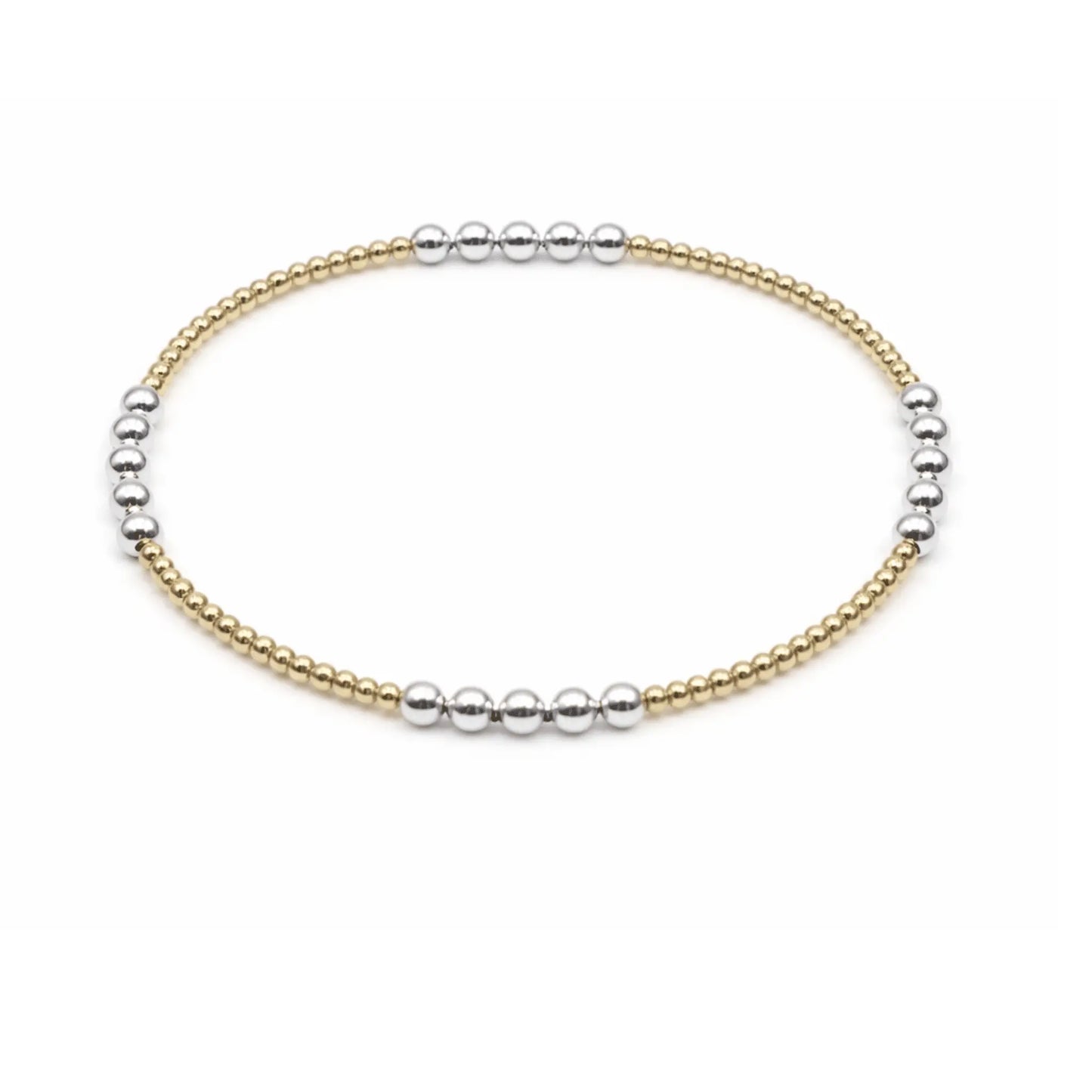 Beaded bracelet featuring mixed metals in a 2x3 design by erin gray, showcasing textured beads and layered style.