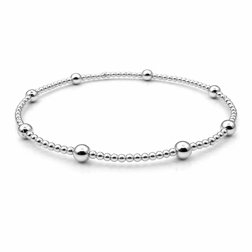 Sterling silver waterproof Karma bracelet with 2mm beads and twelve 4mm beads, crafted by Erin Gray, showcasing elegant jewelry design.