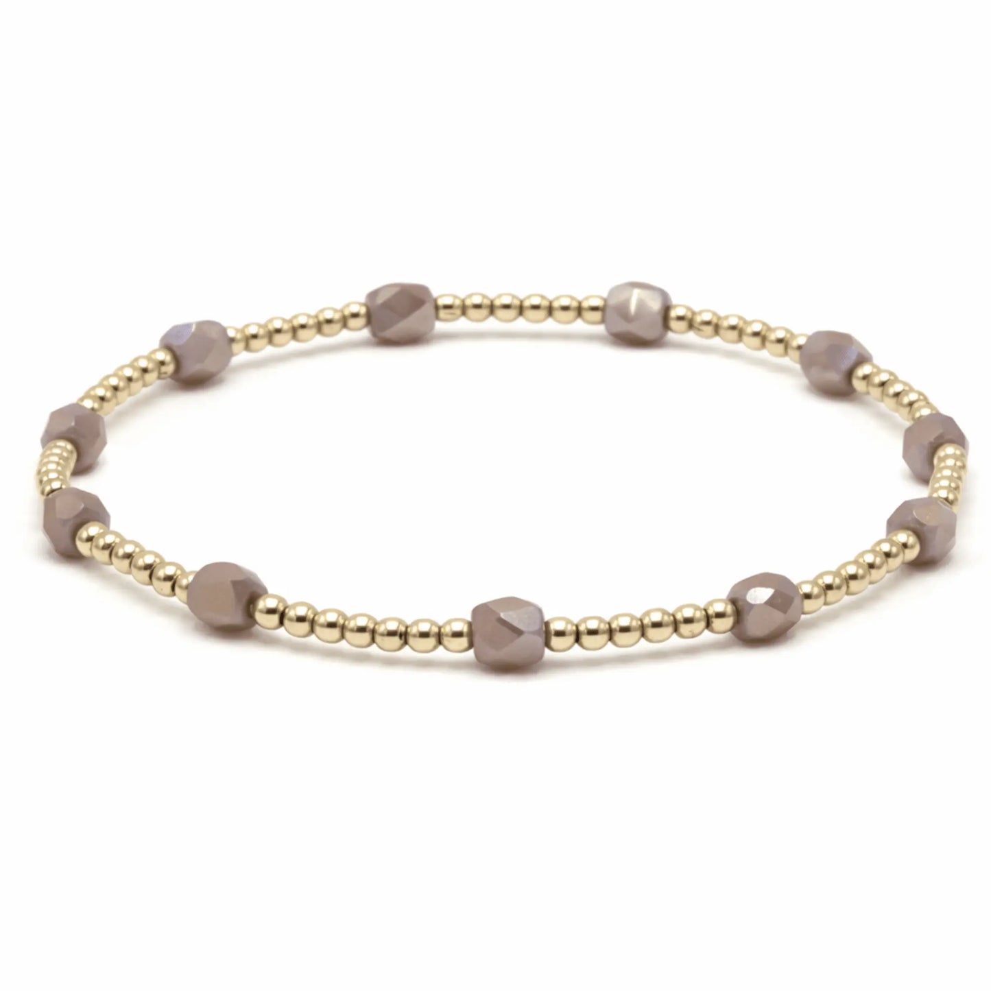 Gold Key West bracelet in mauve by Erin Gray featuring delicate jewelry design on a neutral background.