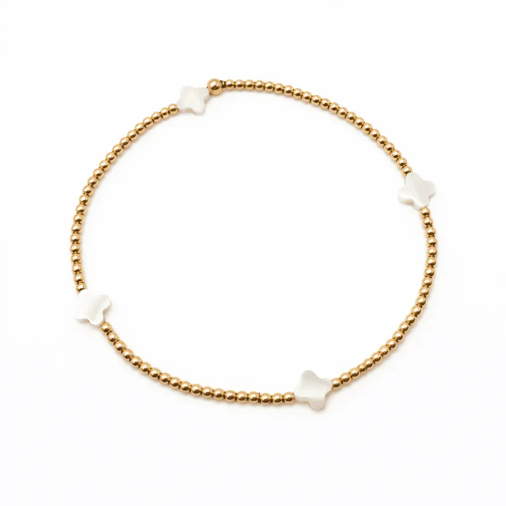 White mother of pearl Lucky Clover bracelet by erin gray, featuring a delicate jewelry design with four-leaf clover charms.