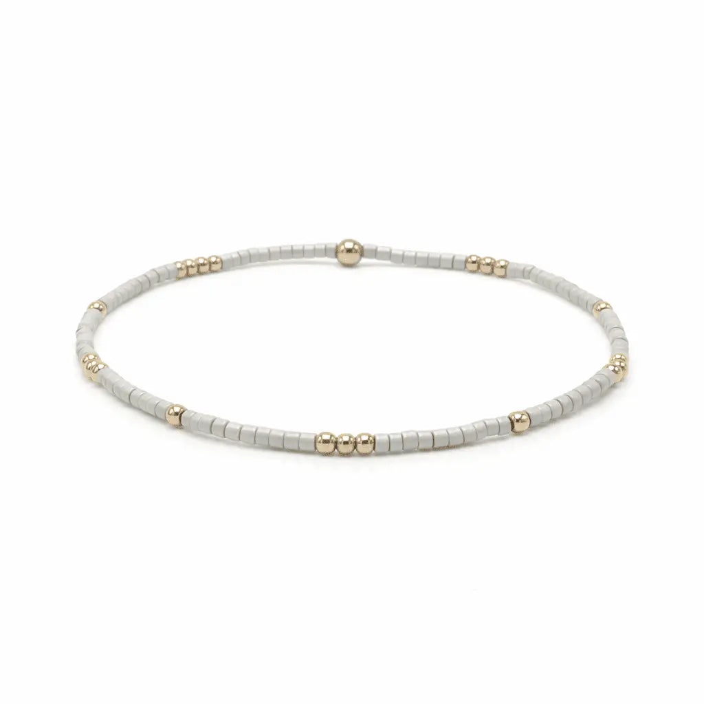 Beaded bracelet with 2mm champagne and gold-filled beads by Erin Gray, waterproof jewelry accessory.