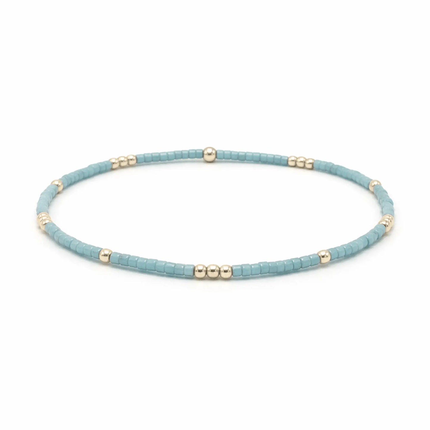 Erin Gray 2mm pale turquoise blue and gold-filled waterproof bracelet with diamond charm jewelry on a white background