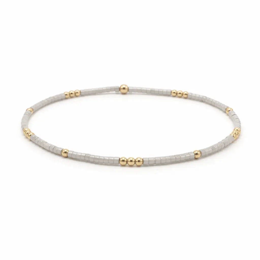 Silver and gold filled beaded waterproof bracelet by Erin Gray featuring 2mm beads in silver and gold tones.