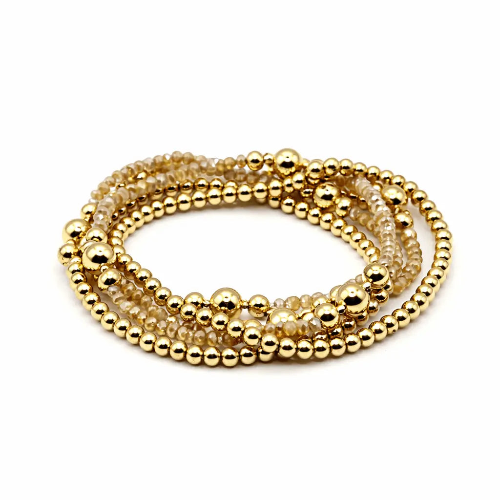 Erin Gray The Peachy Stack jewelry set featuring layered peach-toned bracelets with gold accents on a white background.