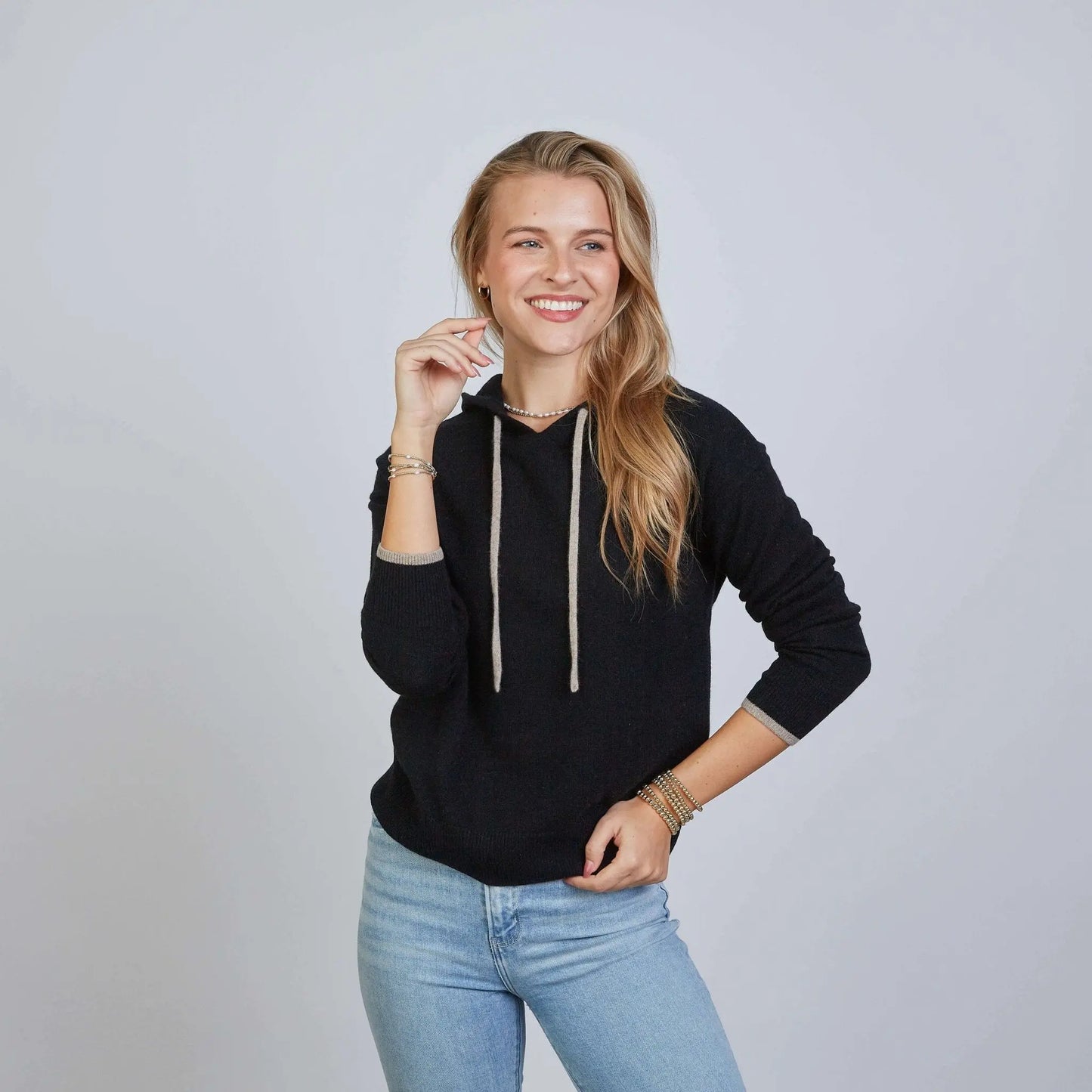 Black Highland Hoodie made from 100% Mongolian cashmere by erin gray, featuring beige accents, cozy and stylish apparel.