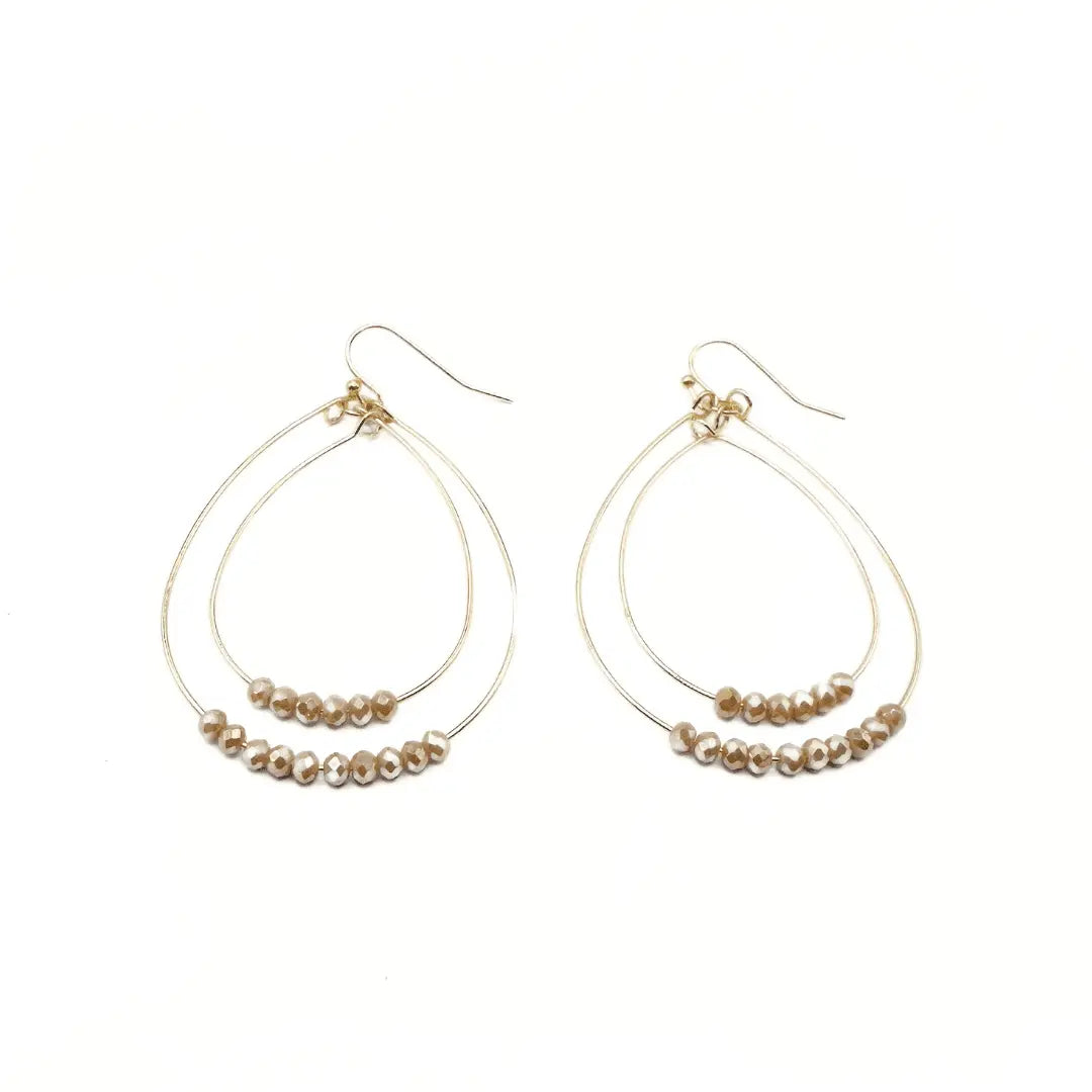 Gold Ella Cate earring in champagne color by erin gray, featuring a delicate jewelry design with a shiny finish.