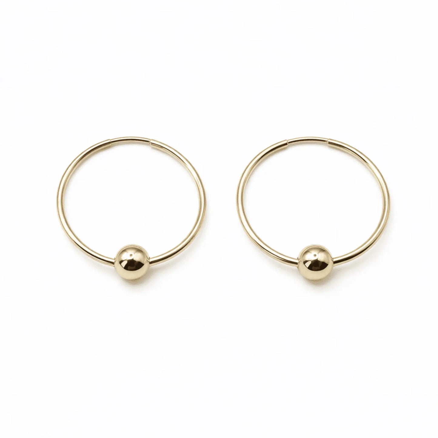 Gold-filled Endless Summer single hoop earring by Erin Gray featuring a sleek gold on gold design for elegant jewelry style.