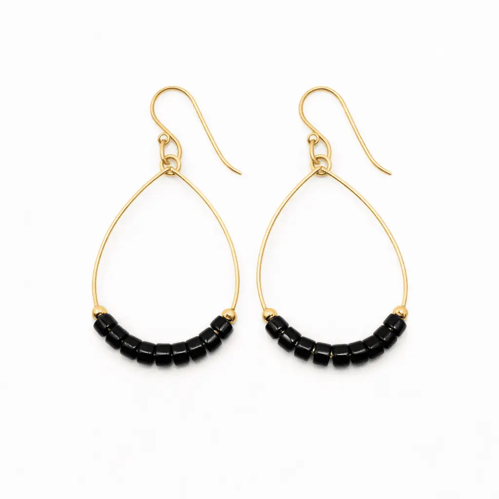 Black Heishi Aster earring by erin gray featuring a waterproof design, displayed with a sleek, minimalist jewelry style.