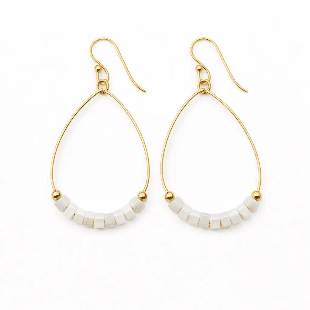 White Heishi Aster earring by erin gray featuring waterproof jewelry design with star-shaped accents.