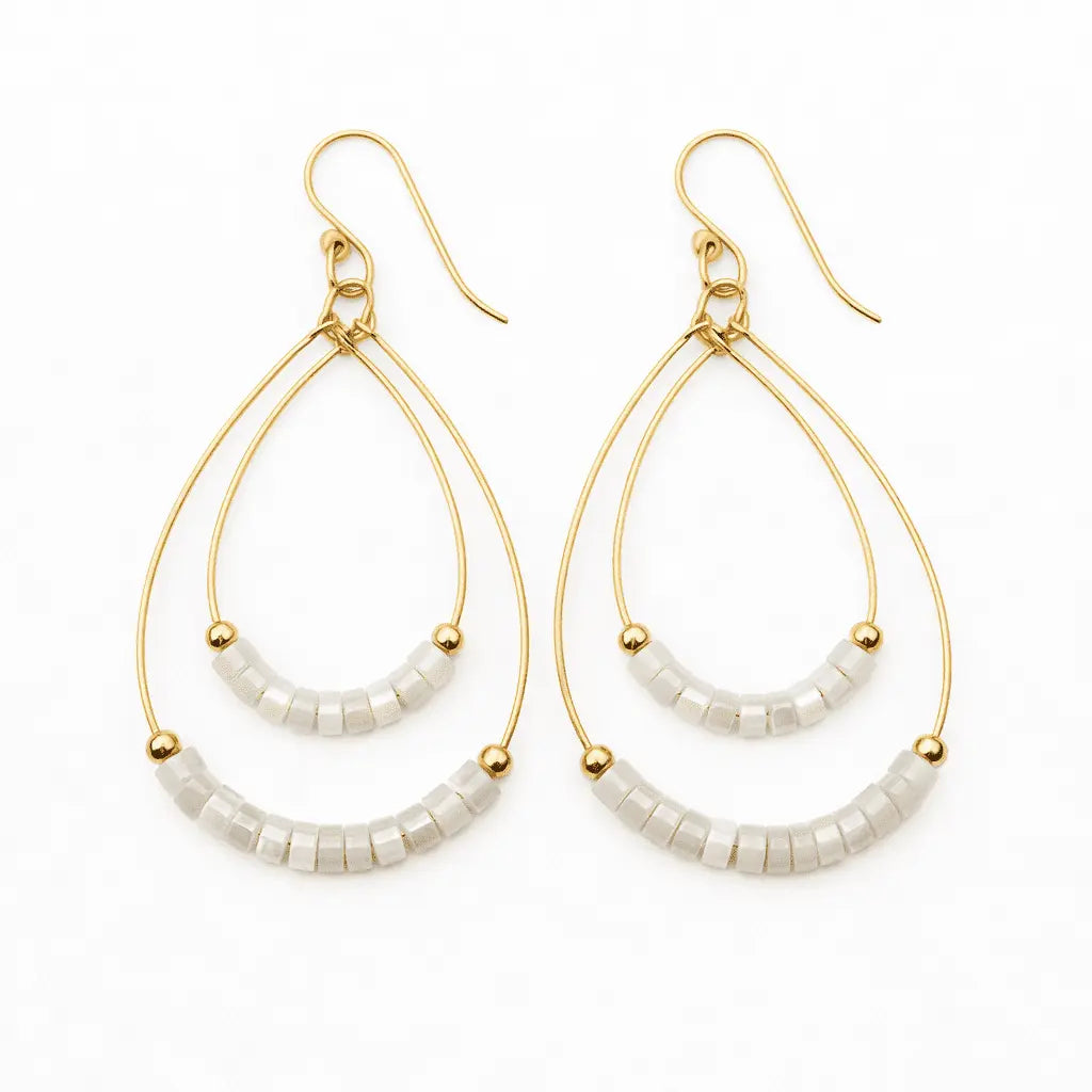 White Heishi Ella Cate earrings by erin gray featuring layered, handcrafted jewelry with a boho-chic style and bead details.