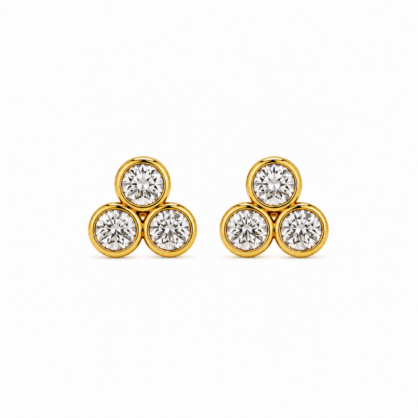 A pair of gold stud earrings, each featuring three round-cut clear gemstones set in a triangular cluster, photographed on a clean white background.