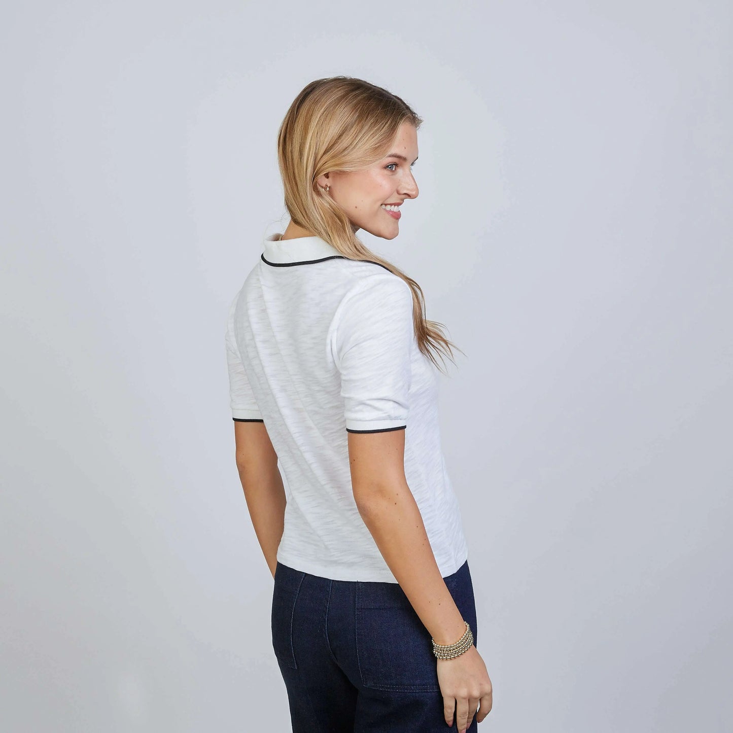 White Piper Polo shirt by erin gray with black contrast piping, short sleeves, classic men's apparel style.