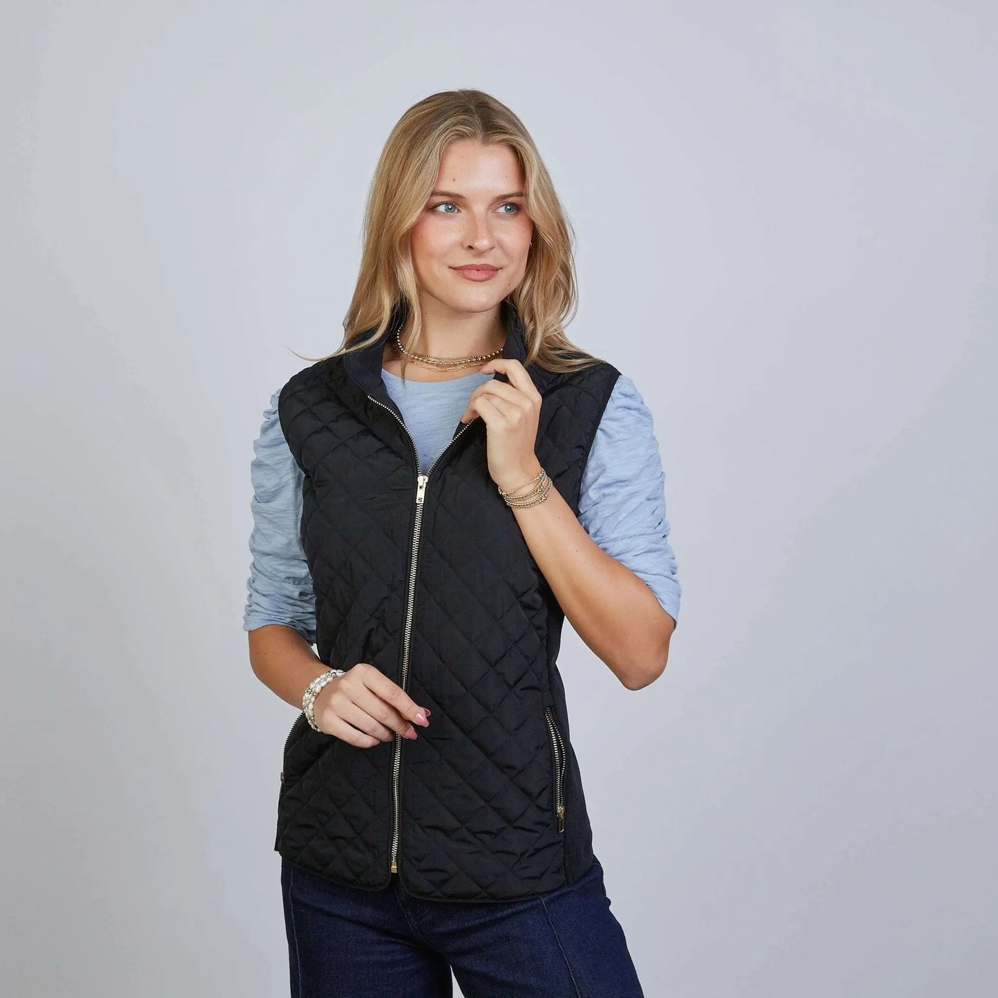 Black Erin Gray The Essential Perfect Fit Puffer Vest worn by a female model, showcasing a stylish, fitted puffer vest in apparel.