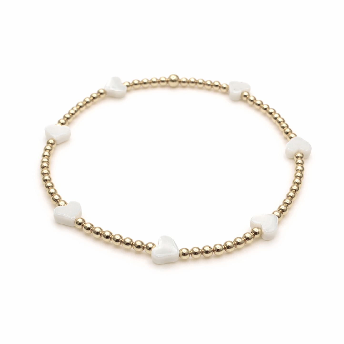 Gold bracelet with white heart beads 