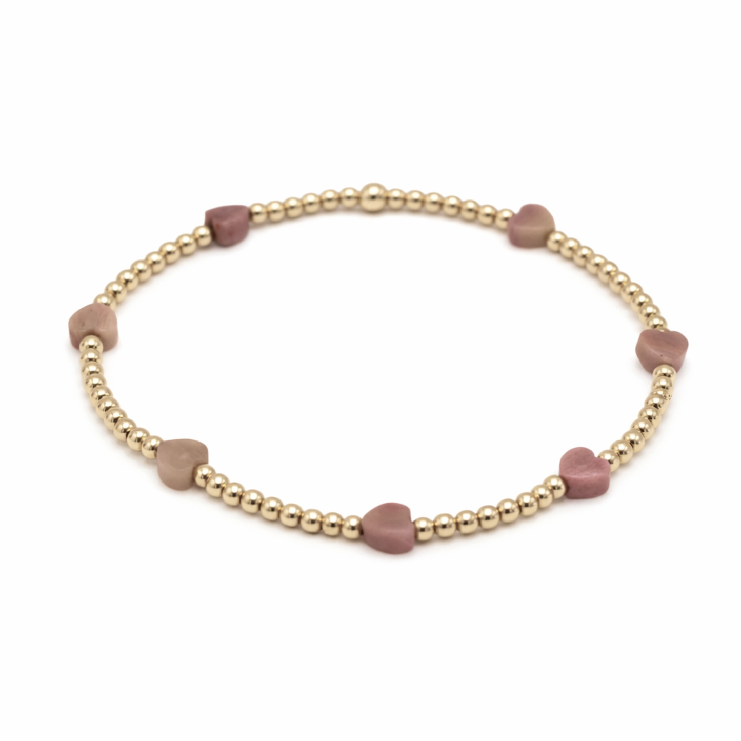 Bracelet with gold beads and pink heart-shaped beads on a white background
