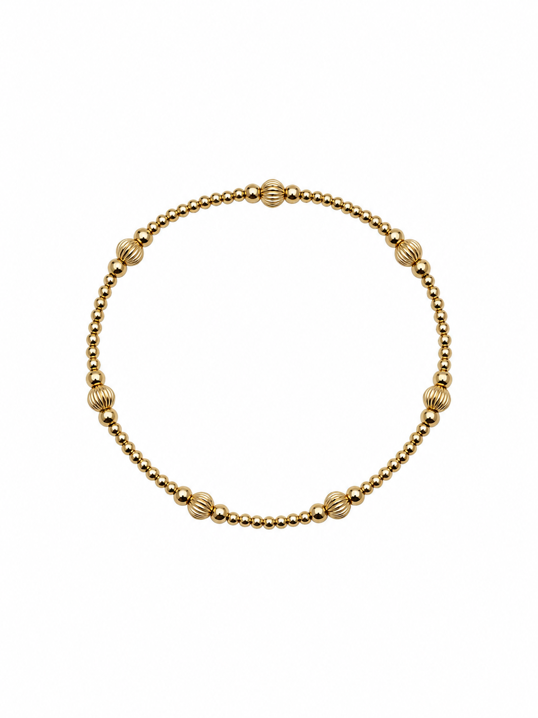 A delicate gold beaded bracelet with alternating smooth and ribbed round beads, displayed on a clean white background.