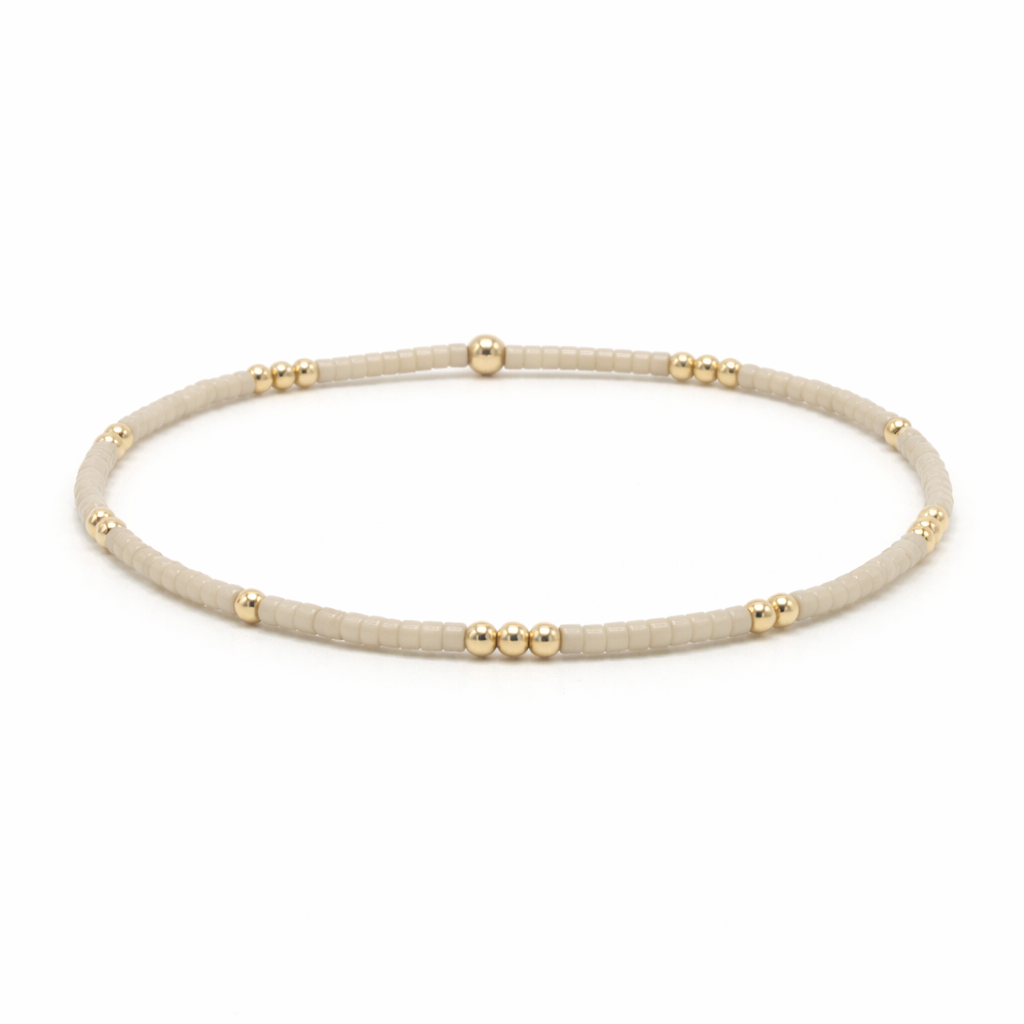 Beige beaded bracelet with gold accents - Erin Gray