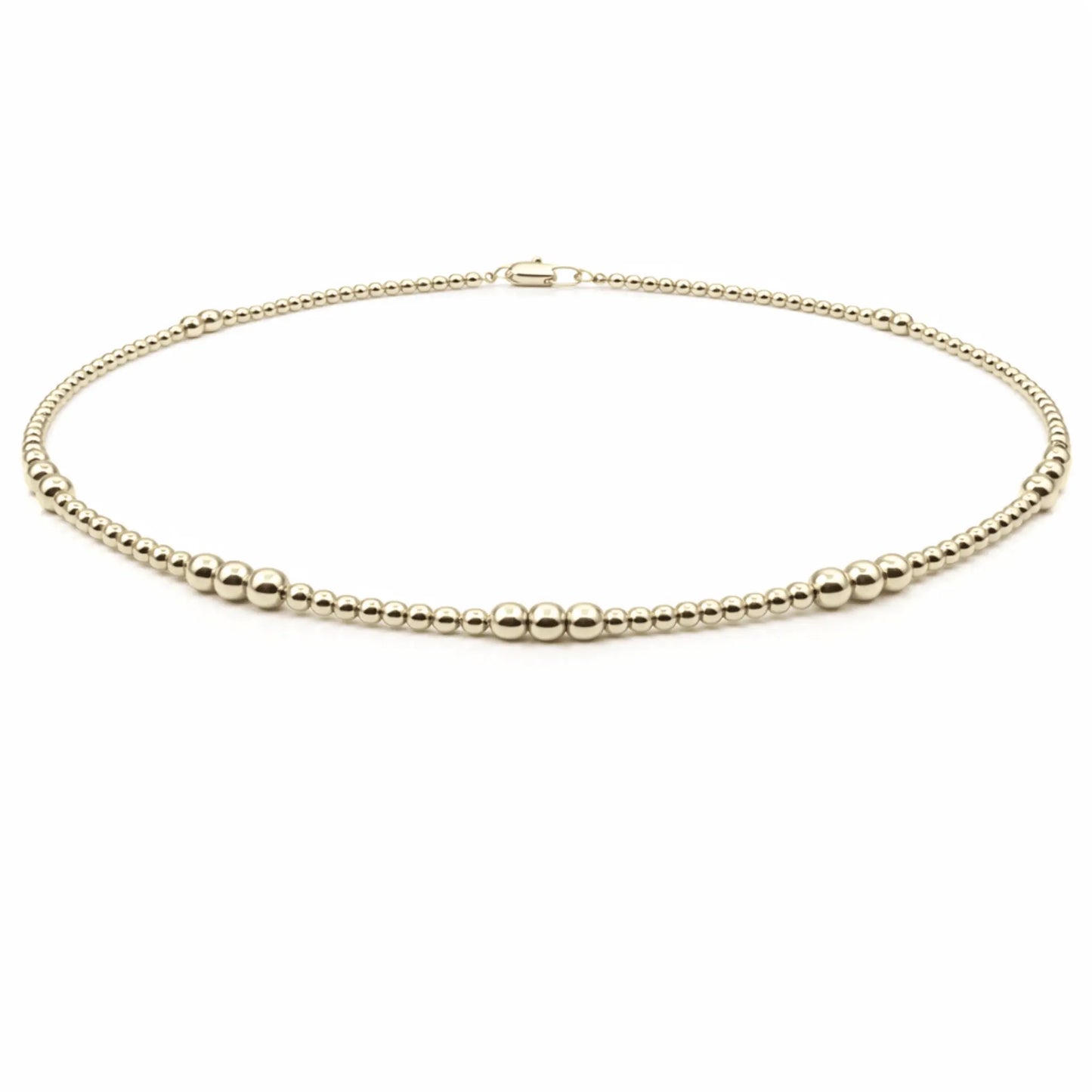 Beaded 14k gold filled waterproof necklace with 2mm and 4mm beads by Erin Gray, showcasing its shiny gold finish and delicate design.