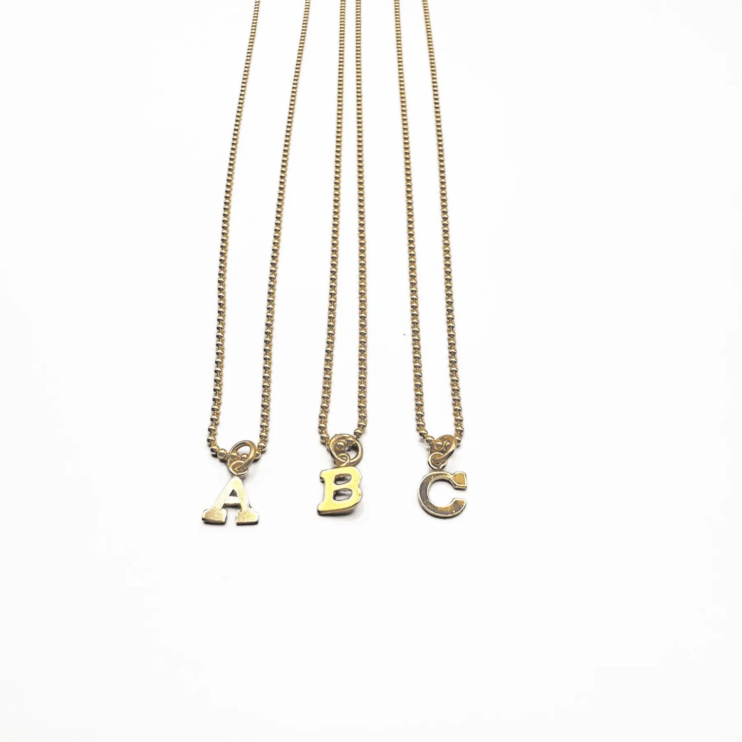 14k gold-filled Baby Bliss Necklace with initial charm, crafted by Erin Gray, featuring elegant jewelry design.