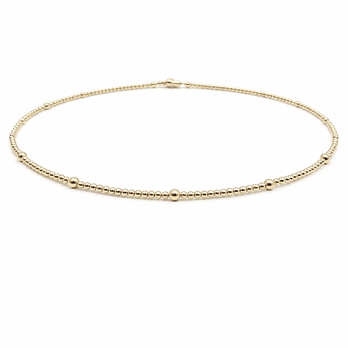 14k gold filled waterproof necklace by Erin Gray, showcasing a sleek, elegant jewelry design with a smooth gold finish.