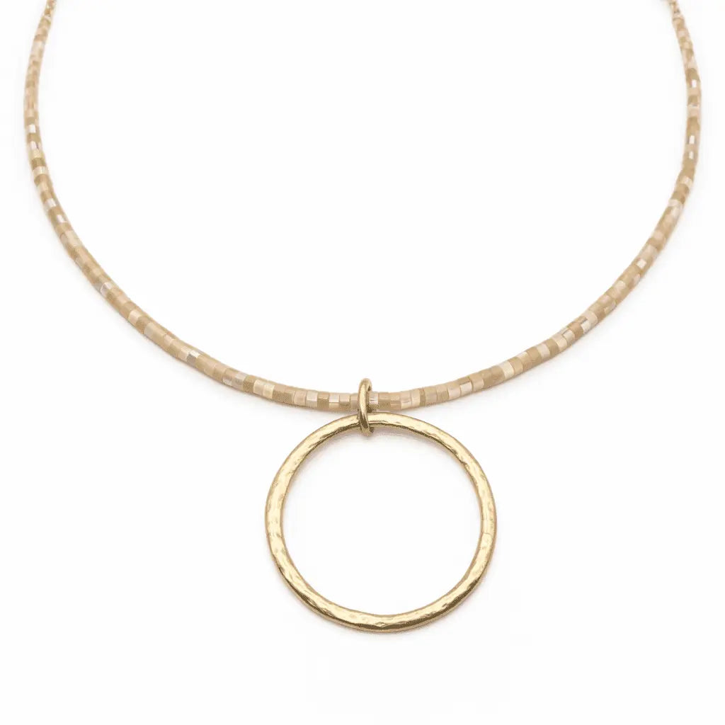 Natural Heishi "Big Gold" necklace by erin gray featuring large gold beads on a delicate chain, close-up view of the jewelry.
