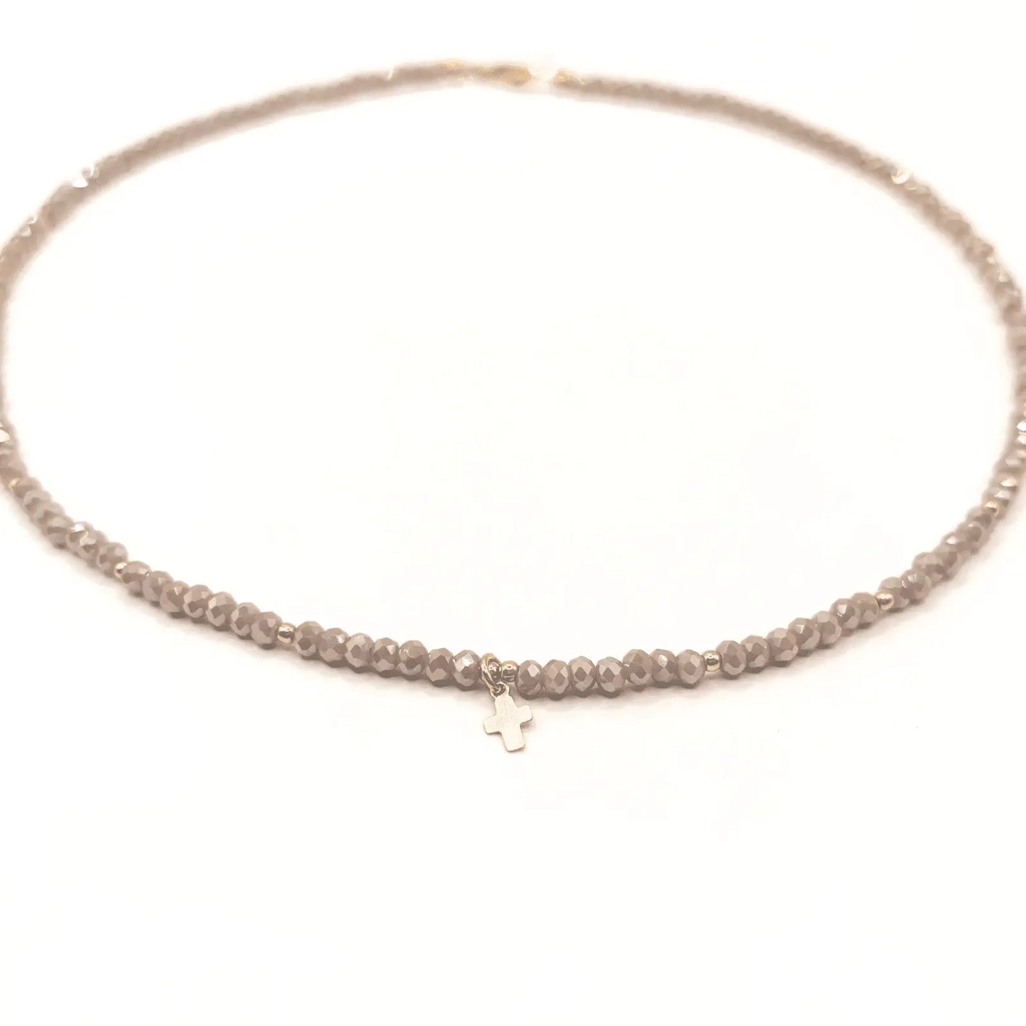 Gold filled Little Luxe Cross necklace on champagne crystal beads, featuring fine jewelry craftsmanship by Erin Gray.