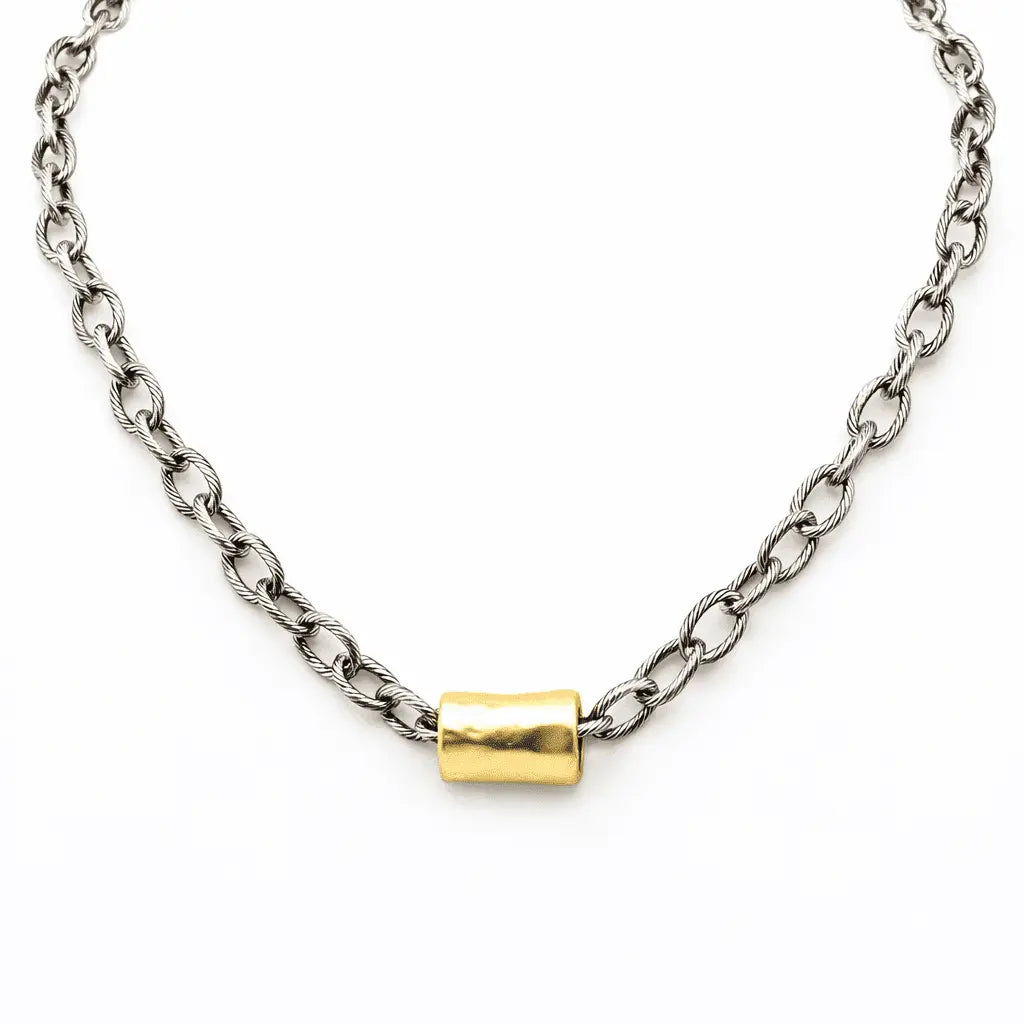 Gold and mixed metal barrel statement necklace by erin gray featuring bold, layered jewelry with a modern design.