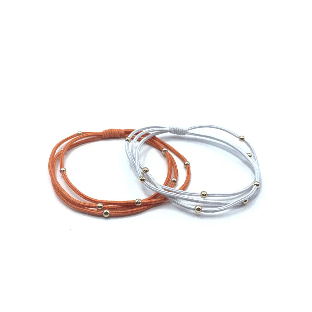 Erin Gray 3mm gold water pony waterproof bracelet hair bands in orange and white, stylish hair accessory for various hairstyles.