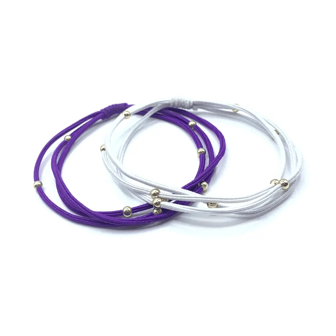 Purple and white 3mm gold water pony waterproof bracelet hair bands by erin gray, styled as versatile hair accessories.