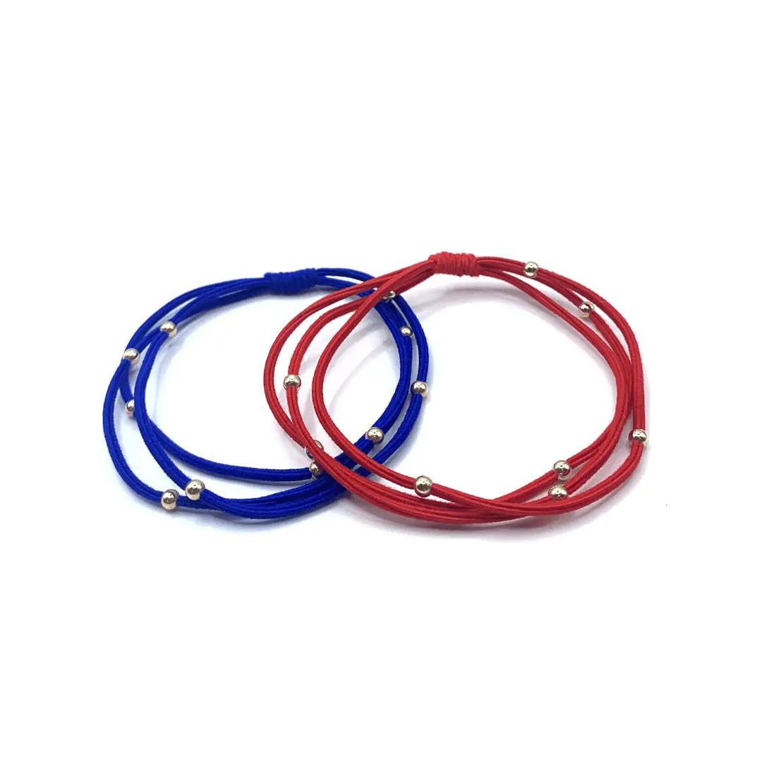 Erin Gray 3mm gold water pony waterproof bracelet hair bands in royal blue and red, stretchy hair accessories for all-day wear.