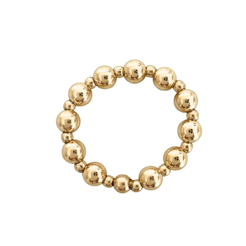 Gold-filled waterproof stretch ring with 4mm and 2mm bands, designed by Erin Gray, showcasing its sleek, flexible jewelry style.