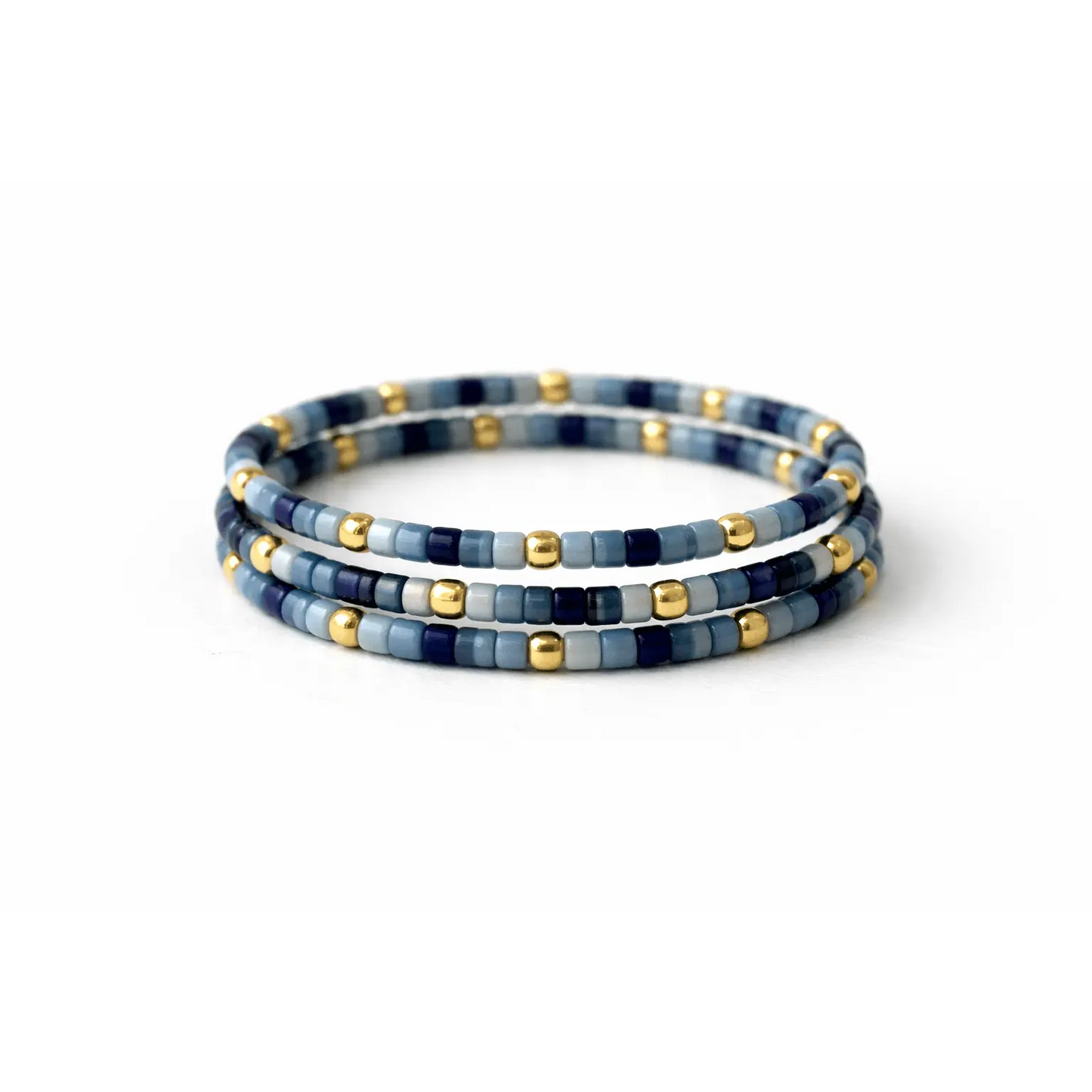 Endless Summer 14k gold-filled and blue stretch ring stack by Erin Gray, featuring layered adjustable jewelry rings.
