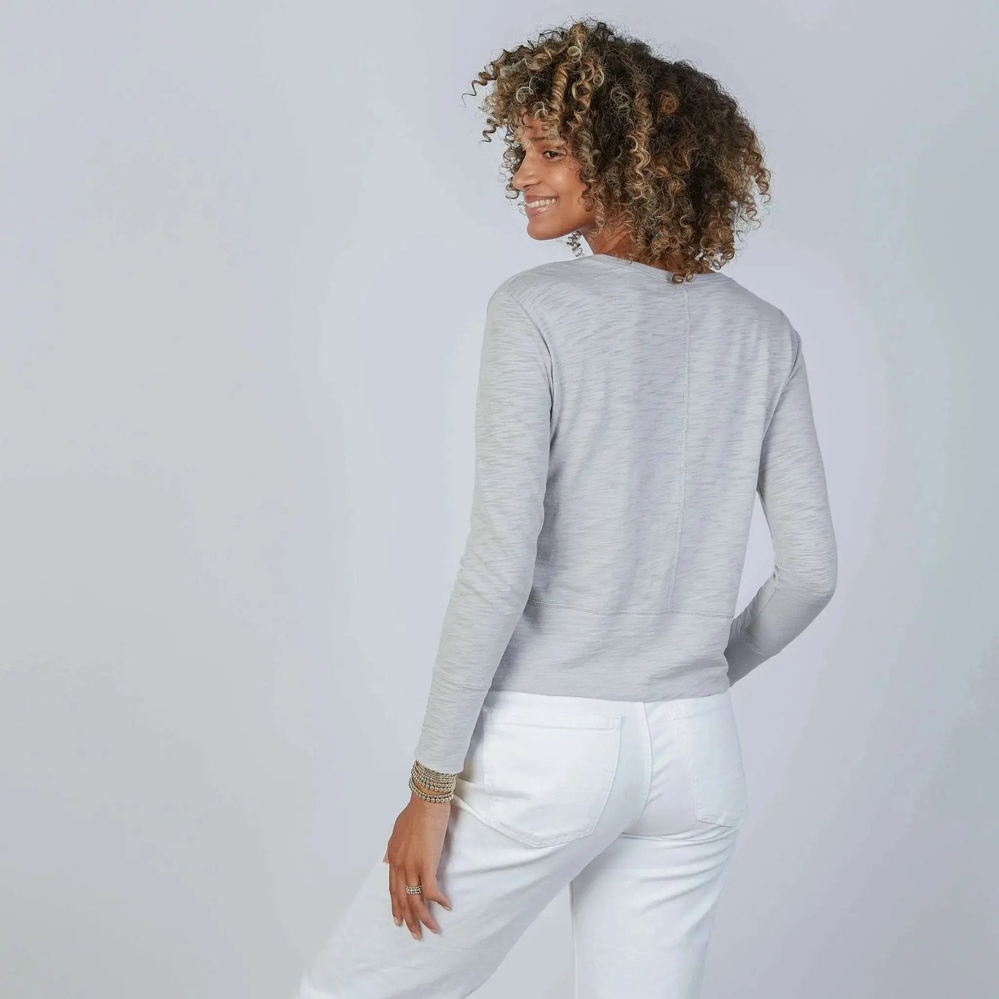 Long sleeve Celia Perfect Length Tee in Light Gray by erin gray, showcasing a casual, fitted knit top with a round neckline.
