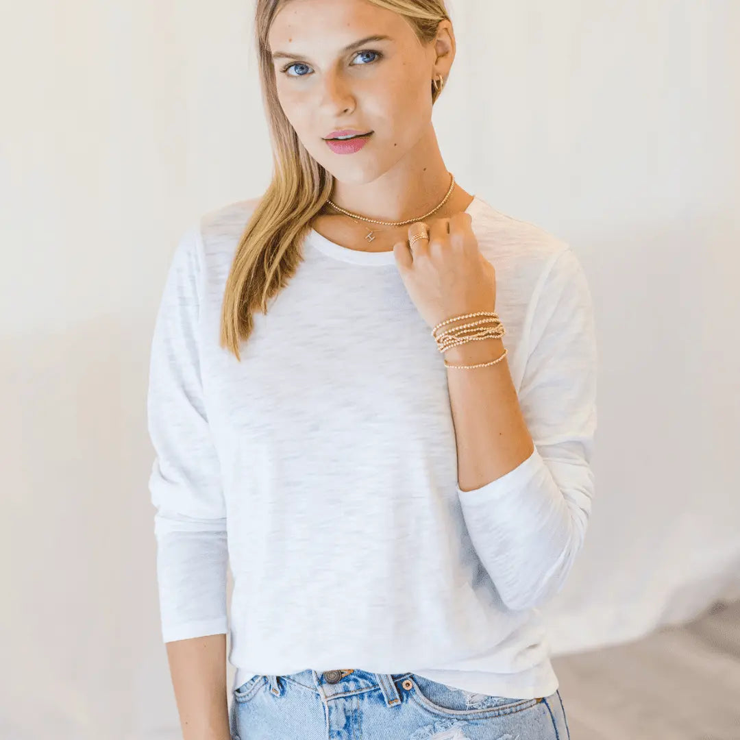 White long sleeve Classic Tee by erin gray, featuring a simple crew neck and relaxed fit, perfect for casual wear.
