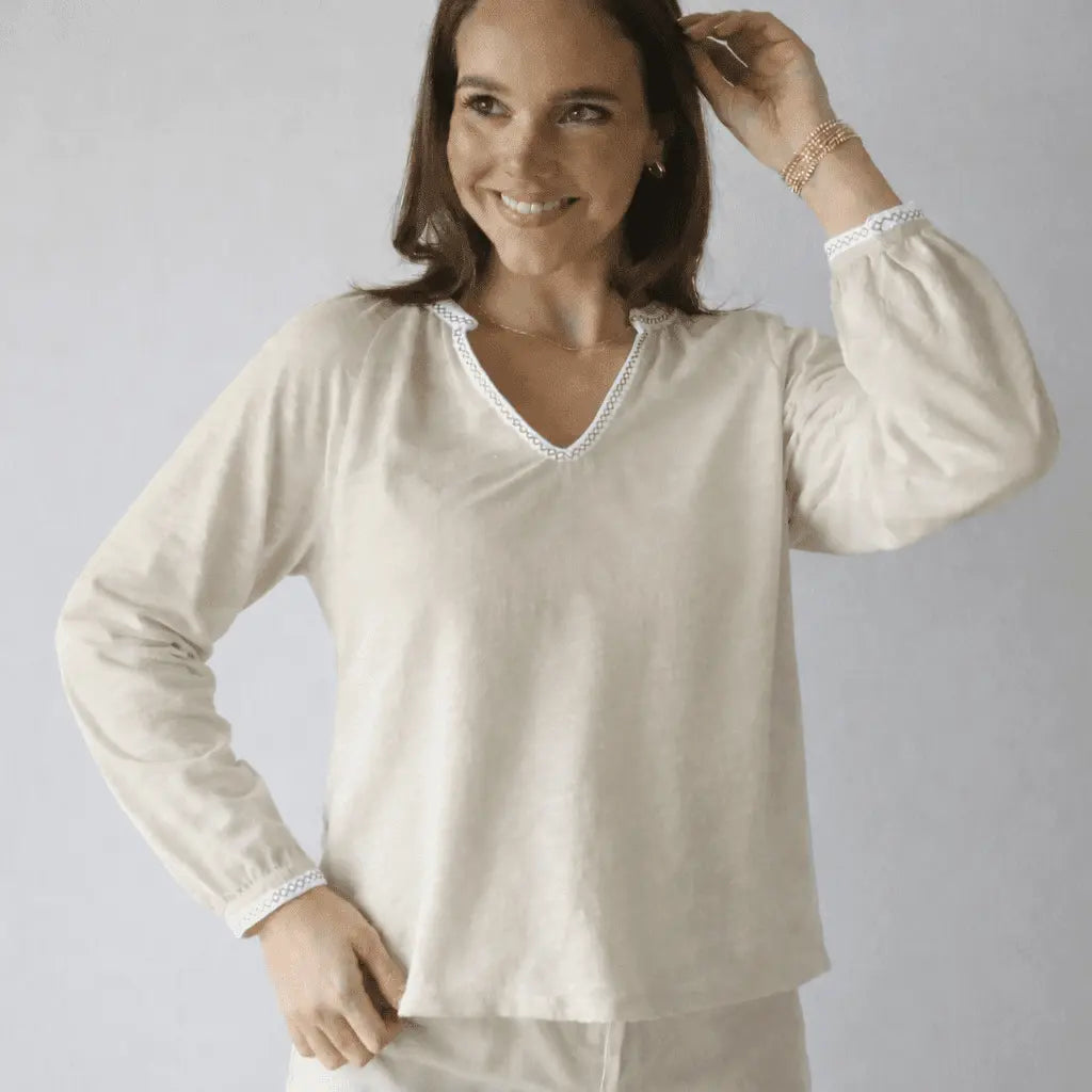 Daisy embroidered long sleeve top in oyster with white stitching by erin gray, featuring delicate floral embroidery and soft fabric.