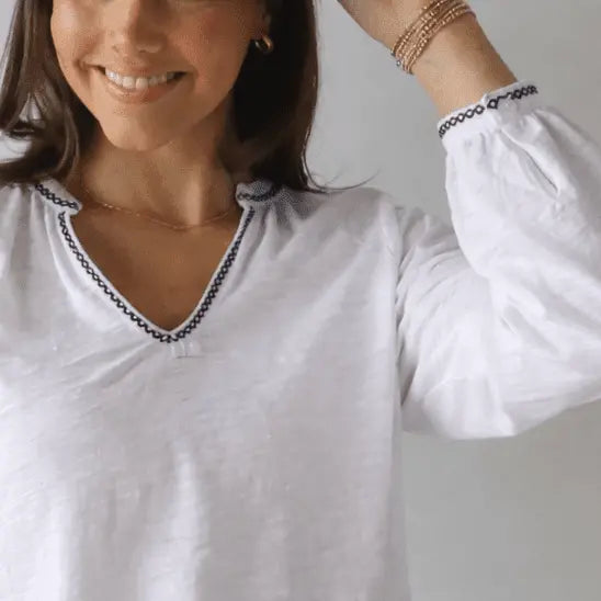 White long-sleeve Daisy embroidered top by erin gray with brown stitch detailing, casual women's apparel.
