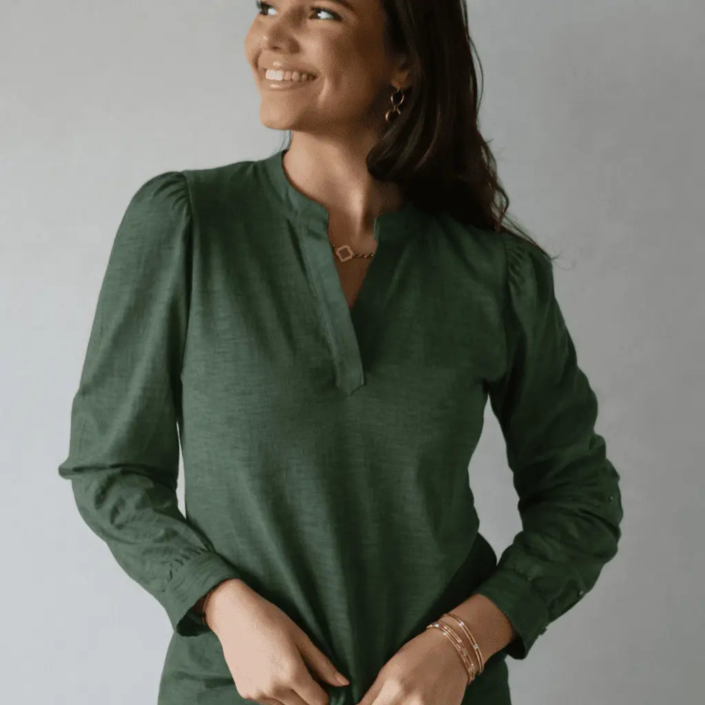 Long sleeve Dolly Top in forest green by erin gray, featuring a fitted silhouette and soft fabric, styled with casual accessories.