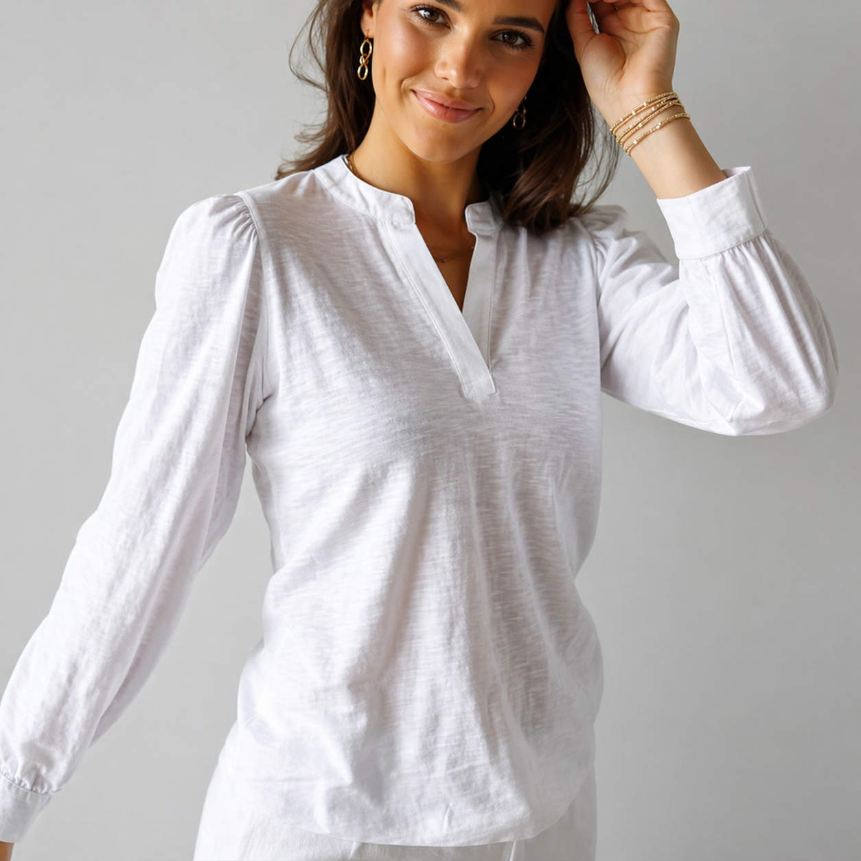 White Dolly Top by erin gray featuring long sleeves and puff shoulders, displayed on a plain background.