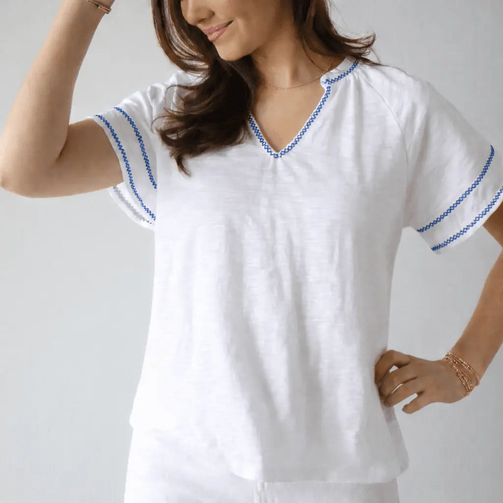 White Daisy embroidered top with blue contrast stitching and flutter short sleeves, by Erin Gray.