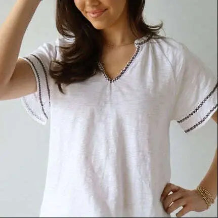 White Daisy embroidered short sleeve top by erin gray with brown stitch detailing, casual women's apparel.
