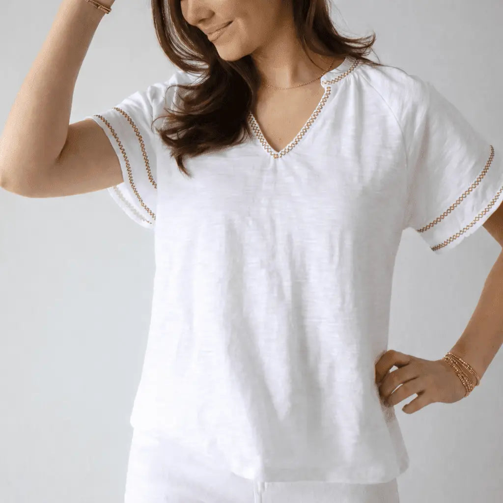White Daisy embroidered short sleeve top by erin gray with khaki stitching, casual women's apparel, detailed floral embroidery.