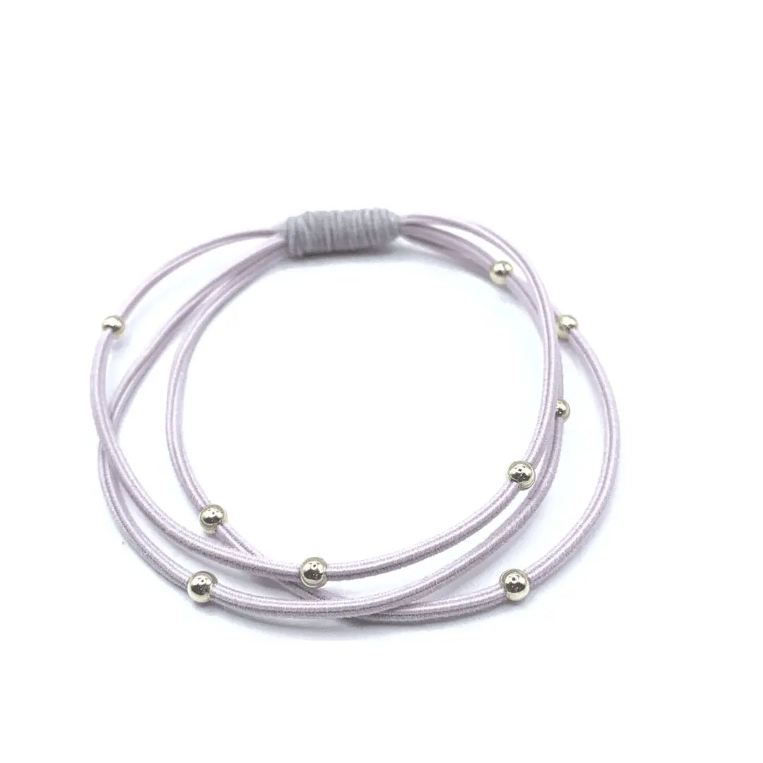Pink and light gray Erin Gray waterproof hair band with a 3mm gold water pony for secure hair styling.